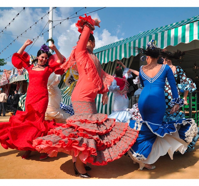 The April Fair in Seville includes flamenco dancing, traditional clothing, music, and food. It is a colorful celebration of Andalusian culture.